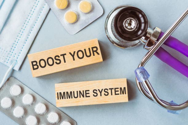 Boost your immune system written on wooden cubes on medical background.