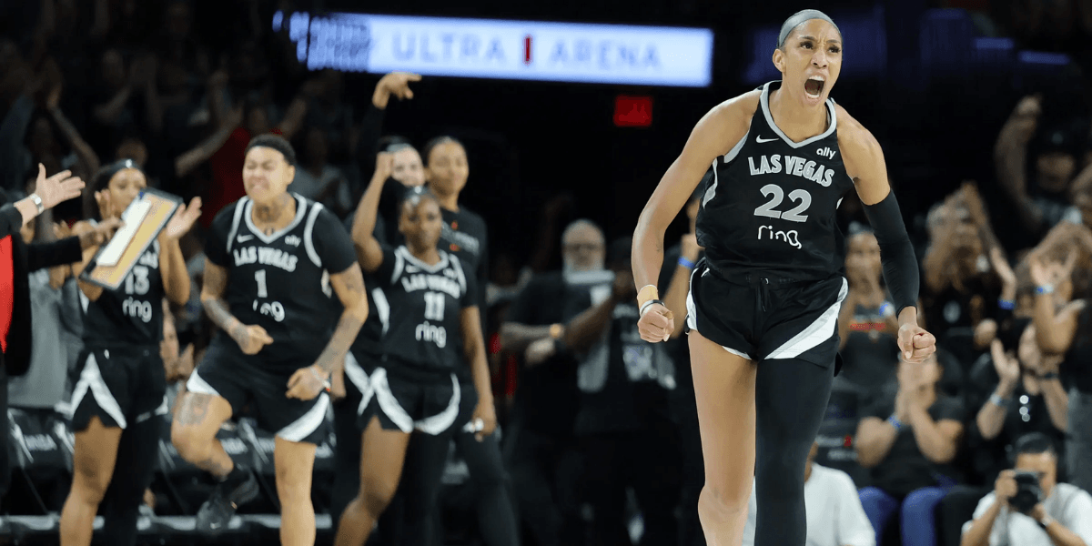 Celebrating basketball players in black jerseys during a tense moment in the game