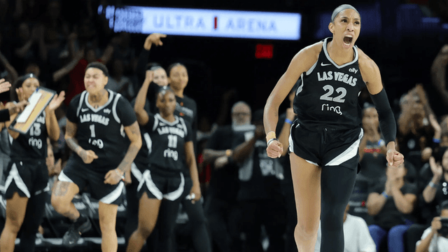 Celebrating basketball players in black jerseys during a tense moment in the game