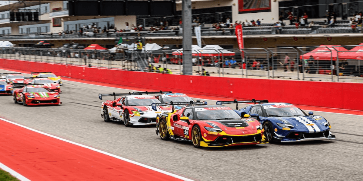 Race cars speeding on a track during a motorsport event with spectators in background