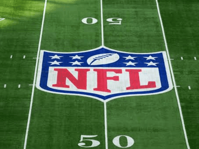 NFL logo centered on a green football field with yard markers visible