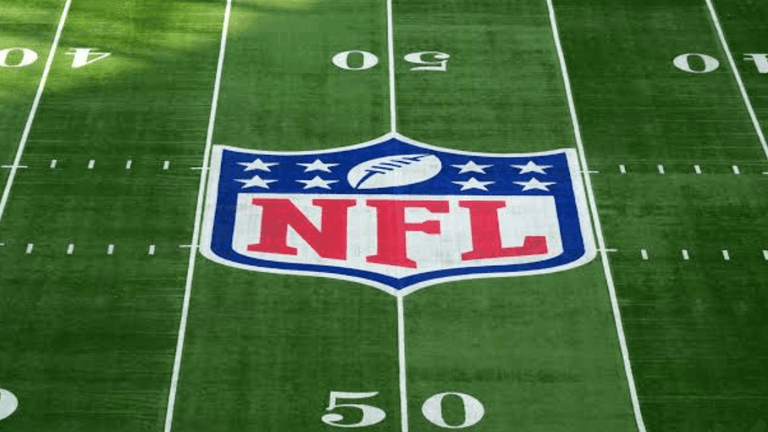 NFL logo centered on a green football field with yard markers visible