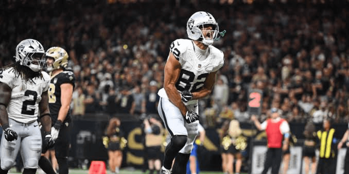 Football player celebrates a touchdown during an NFL game in a stadium
