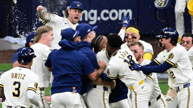 Baseball team celebrating a victory with excitement and champagne in a stadium setting