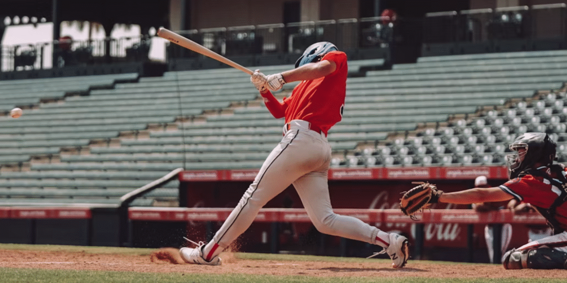 Baseball player swings at a pitch during an MLB game as the catcher reaches for the ball behind home plate.